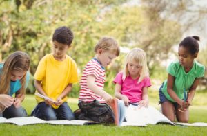 kids reading outdoors